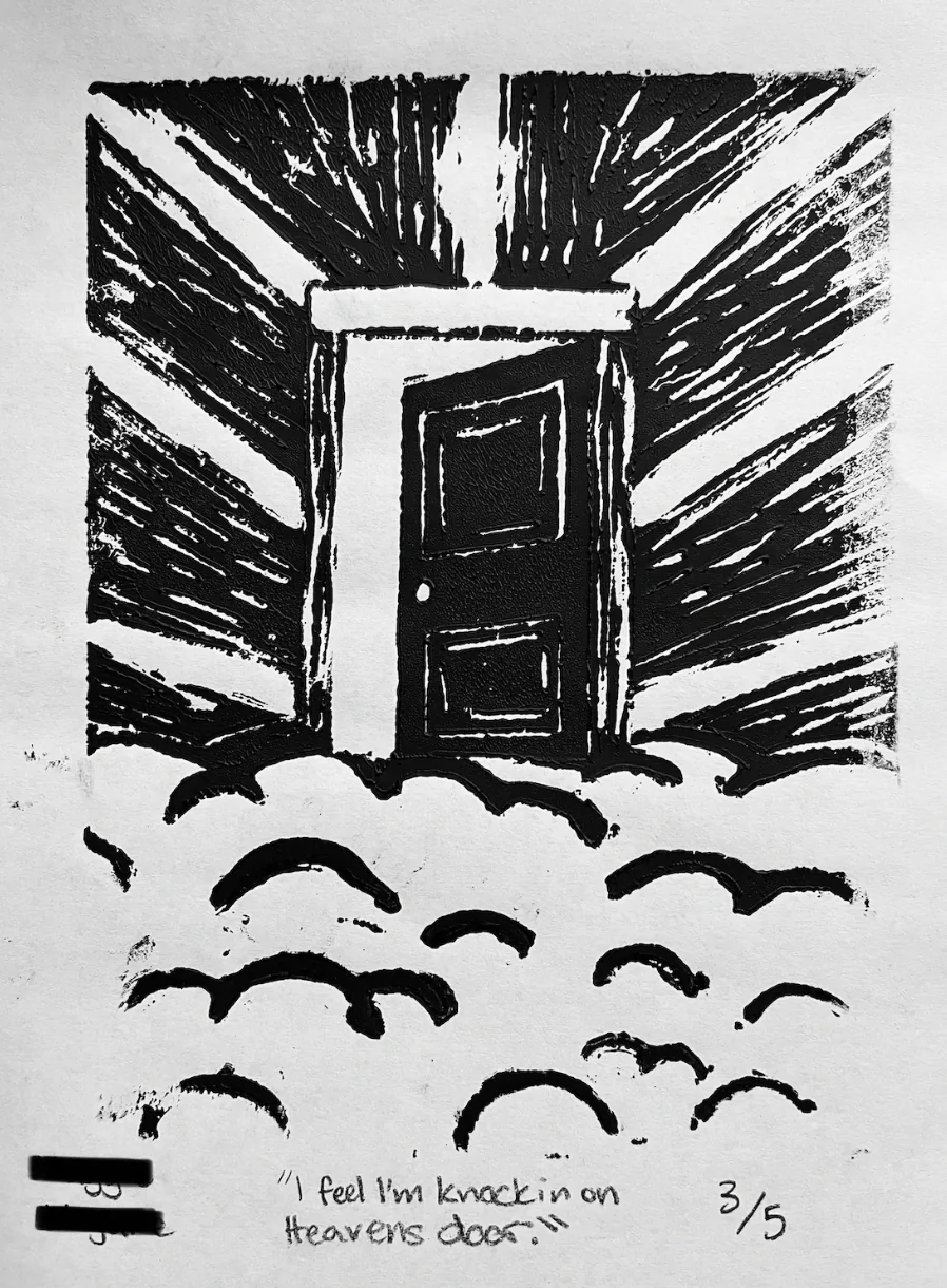 A black-and-white linocut print of an open doorway with birds flying out over water.